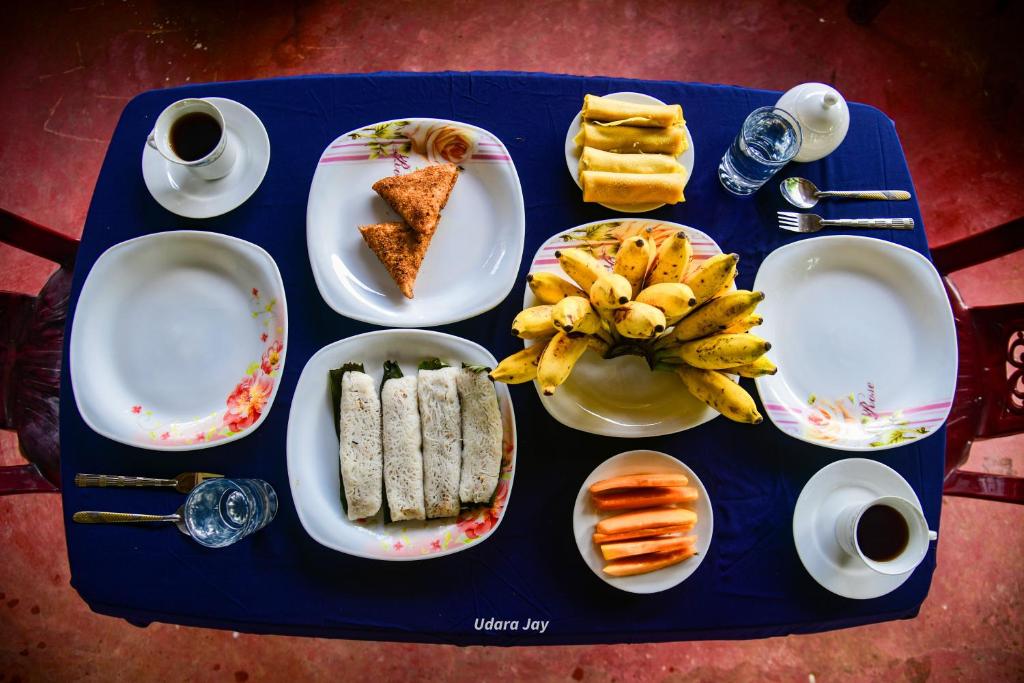a blue table with plates of food on it at Maka Safari Village Resort in Udawalawe