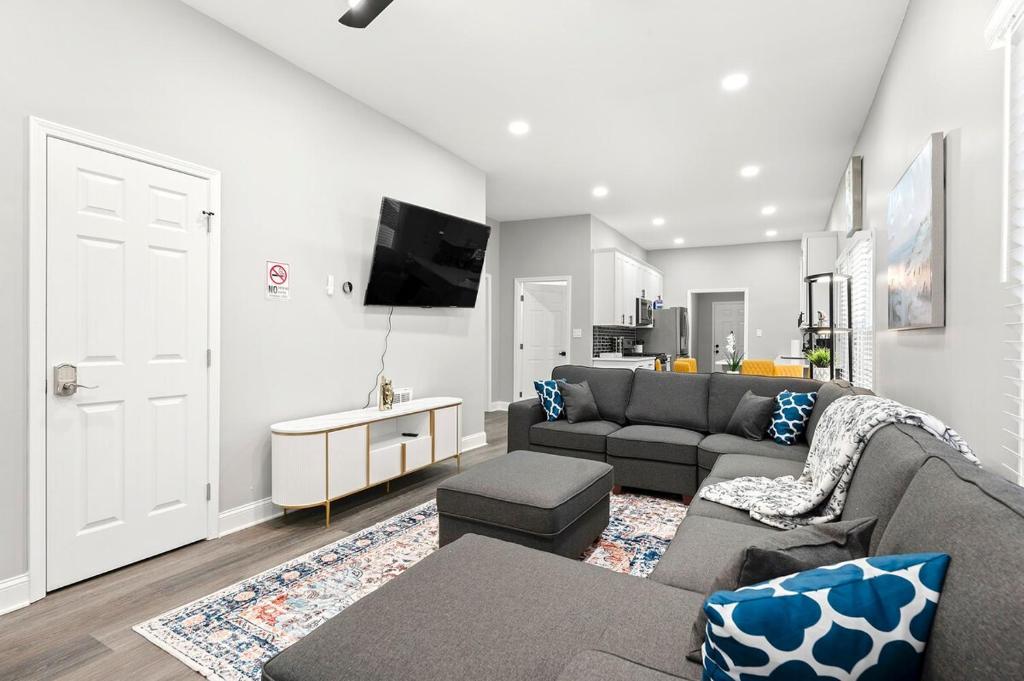 a living room with a couch and a tv at Atlanta Modern Escape Prime Location & Spacious Living sleeps 14 in Atlanta