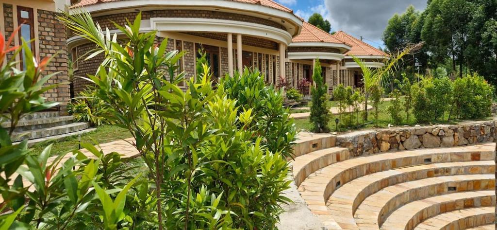 a house with a garden in front of it at 6 Engo Cottage - Benanda Forest Resort in Masaka