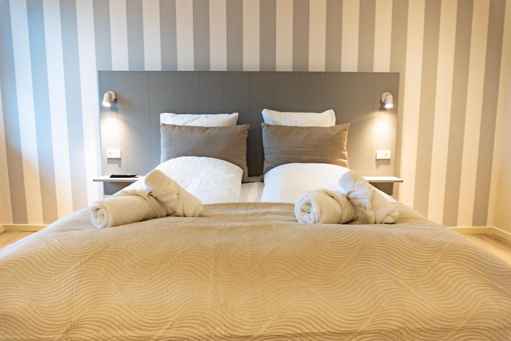 Postel nebo postele na pokoji v ubytování Hotel Ulfborg