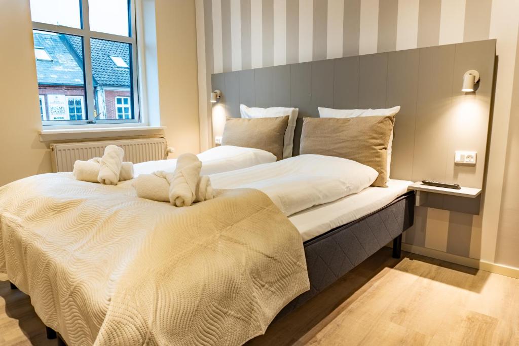 Postel nebo postele na pokoji v ubytování Hotel Ulfborg