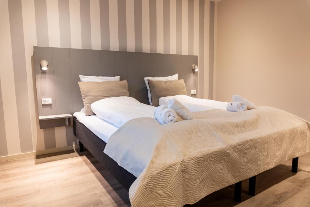 Postel nebo postele na pokoji v ubytování Hotel Ulfborg