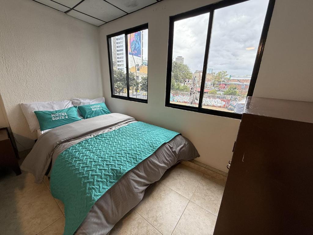 Postel nebo postele na pokoji v ubytování Hotel Suite Centro Bogotá