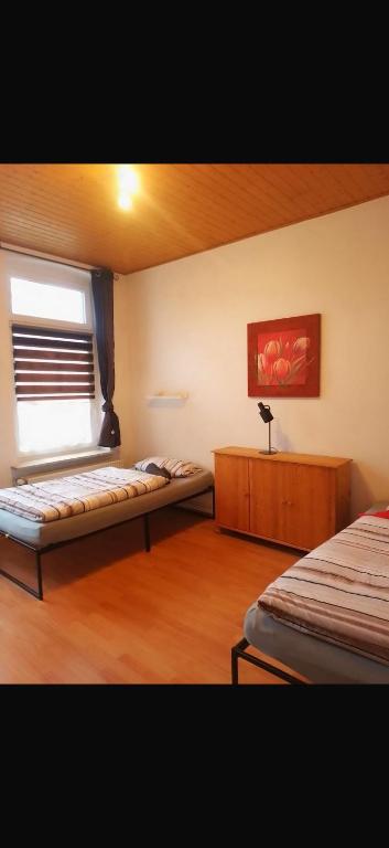 a room with two beds and a window in it at Ferien Wohnung Elmaci in Itzehoe