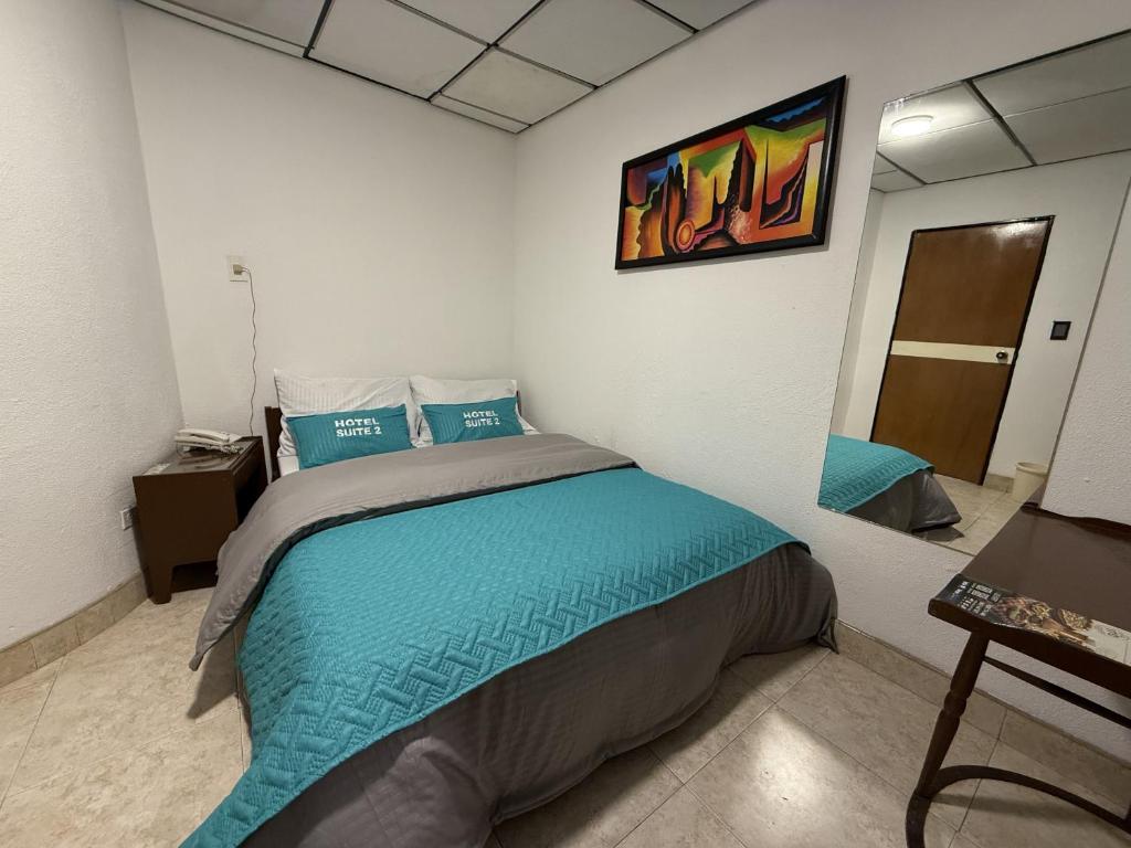 Postel nebo postele na pokoji v ubytování Hotel Suite Centro Bogotá