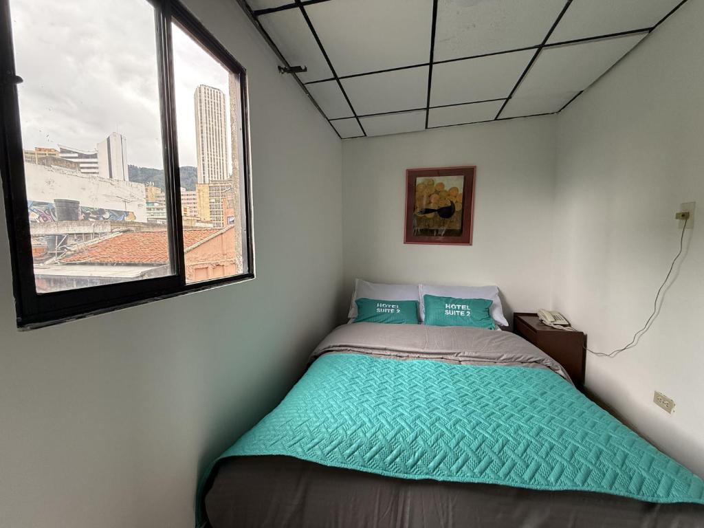 Postel nebo postele na pokoji v ubytování Hotel Suite Centro Bogotá