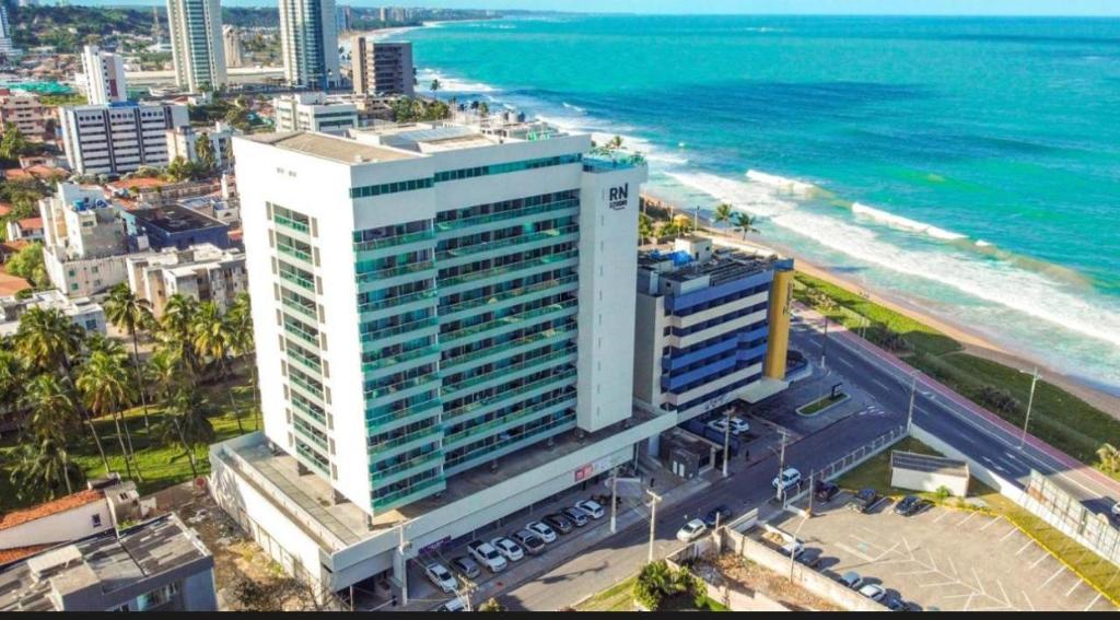an aerial view of a tall building next to the ocean at Rn Studio in Maceió
