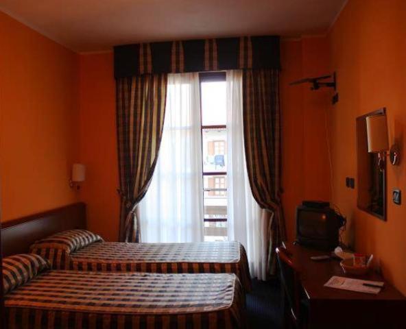 Postel nebo postele na pokoji v ubytování Hotel Tre Denti