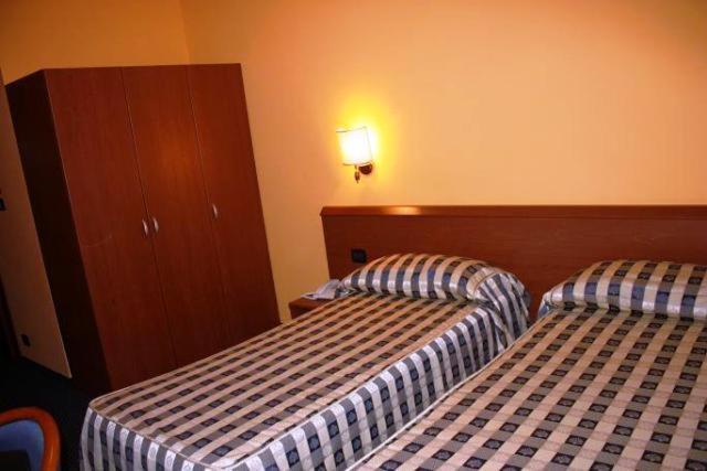 Postel nebo postele na pokoji v ubytování Hotel Tre Denti