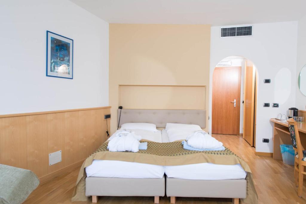 Postel nebo postele na pokoji v ubytování Hotel Venezia