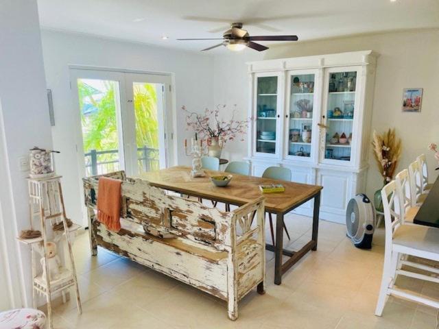 a dining room with a wooden table and chairs at Luxury Oceanfront Elegancia in Kralendijk
