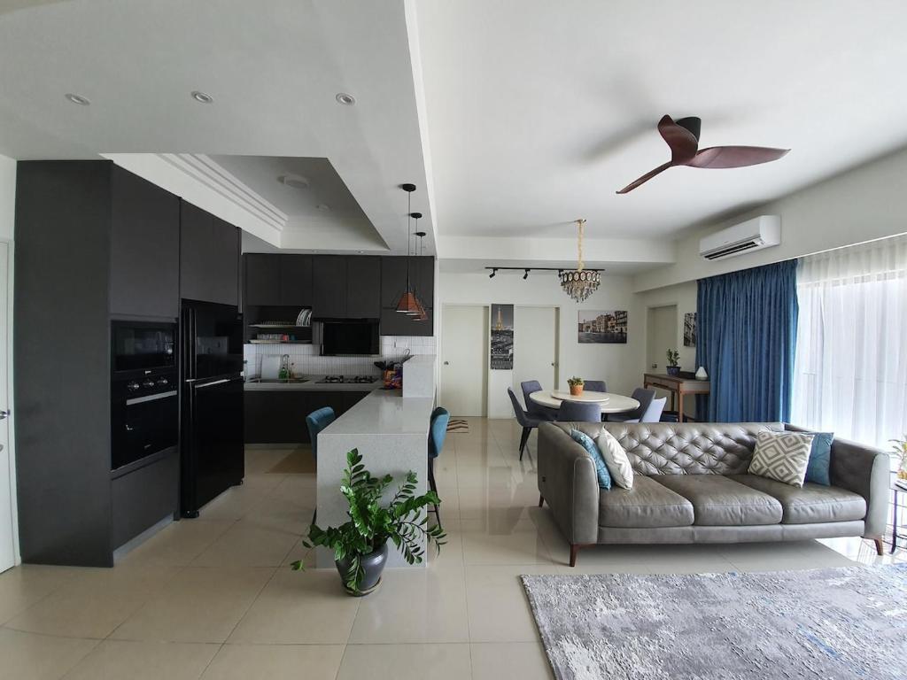 a living room and kitchen with a couch and a table at LoveStayBangi - Lake View, Sunway Gandaria, Bangi in Bandar Baru Bangi