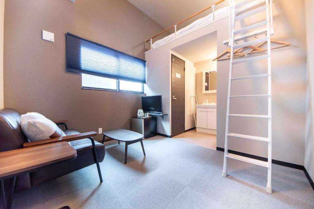 a bedroom with a loft bed and a living room at LOCO Minamiichi in Nara