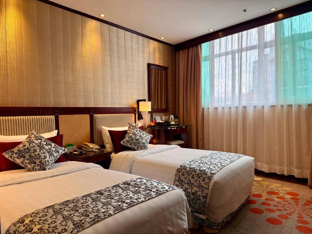 Postel nebo postele na pokoji v ubytování Macau Masters Hotel