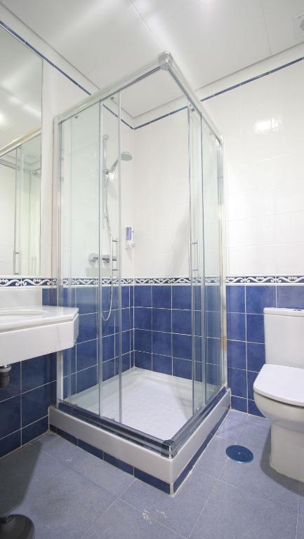a bathroom with a shower and a toilet and a sink at Rincón de Gran Vía in Madrid