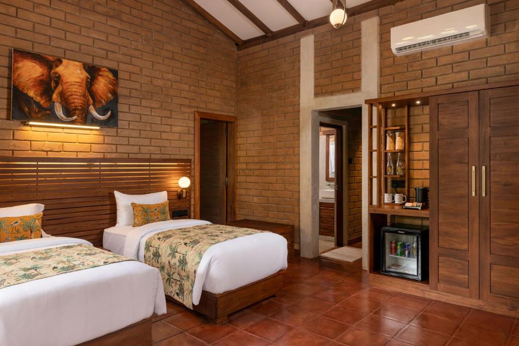 Postel nebo postele na pokoji v ubytování Dhalaya Resort Udawalawe