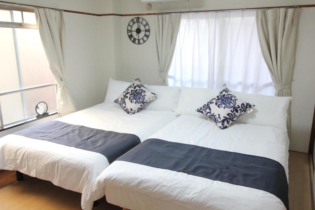 Postel nebo postele na pokoji v ubytování Hotel LUANA in Shin-Nakano