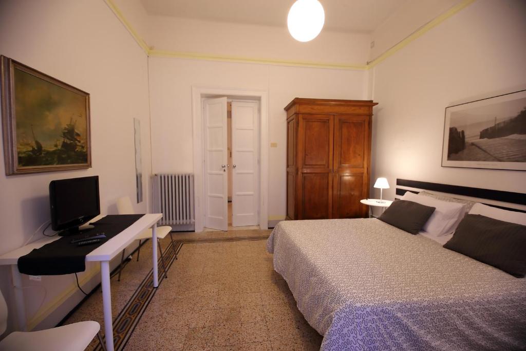 a bedroom with a bed and a desk with a computer at Room and Suite - BARI CENTRALE - in Bari