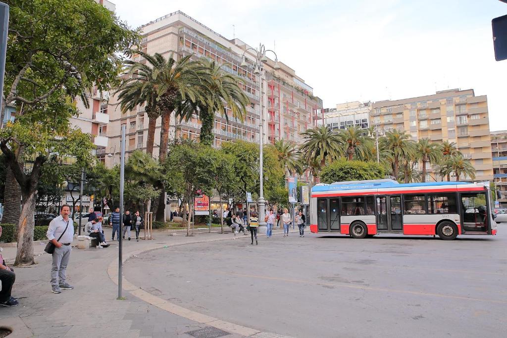 a bus driving down a street in a city at Room and Suite - BARI CENTRALE - in Bari