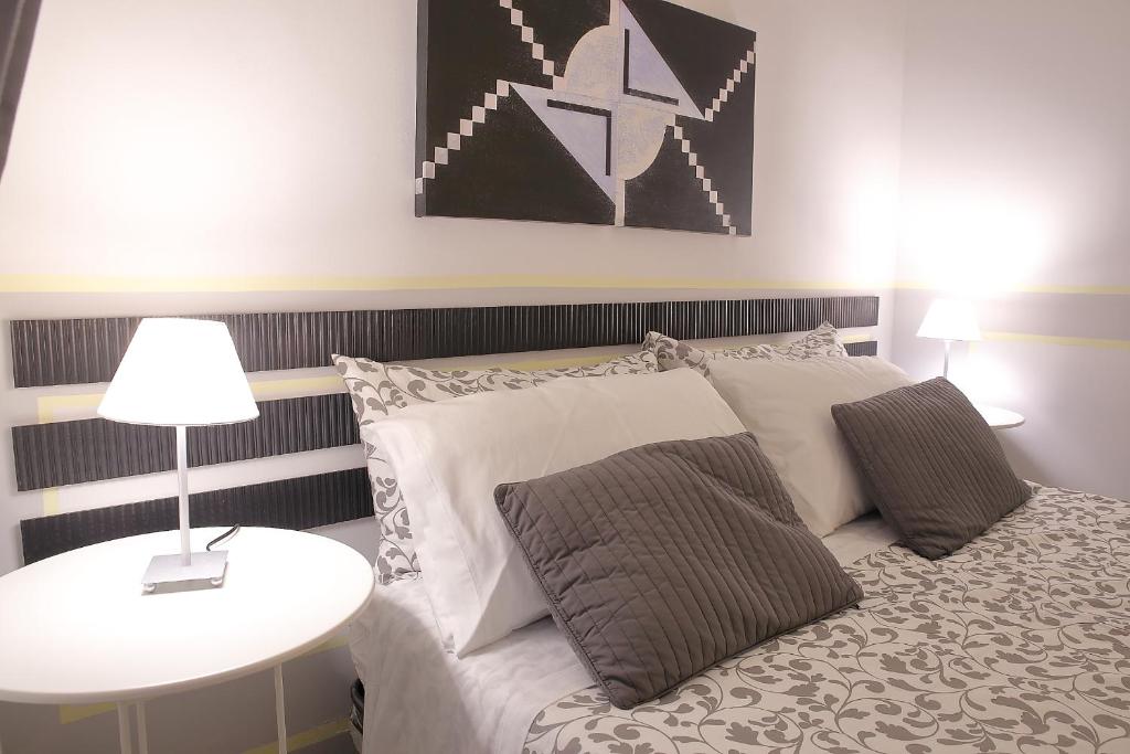 a bedroom with a bed and a table with a lamp at Room and Suite - BARI CENTRALE - in Bari