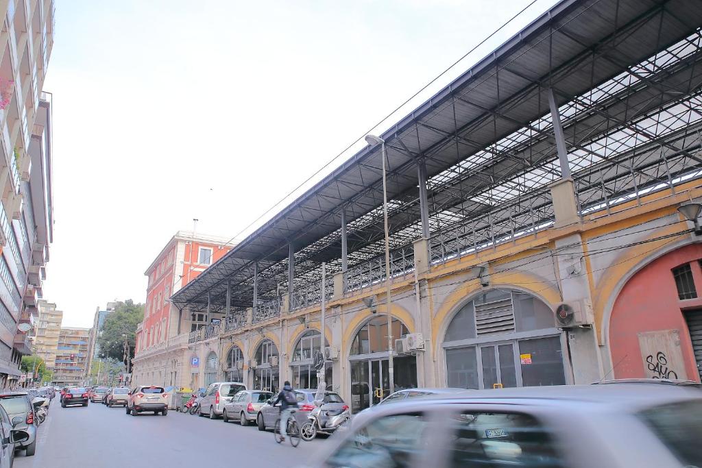 a city street with cars parked in front of a building at Room and Suite - BARI CENTRALE - in Bari