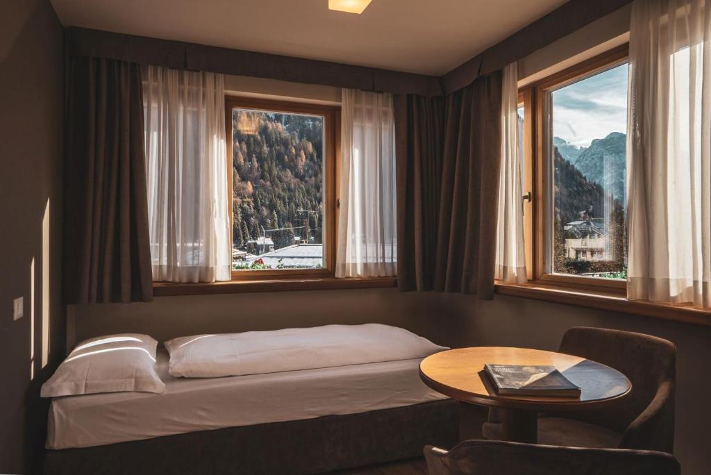 Postel nebo postele na pokoji v ubytování Hotel Crozzon