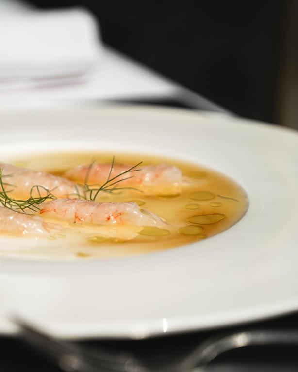 a plate of food with shrimp on a plate at Locanda Gaudemus Boutique Hotel in Sistiana