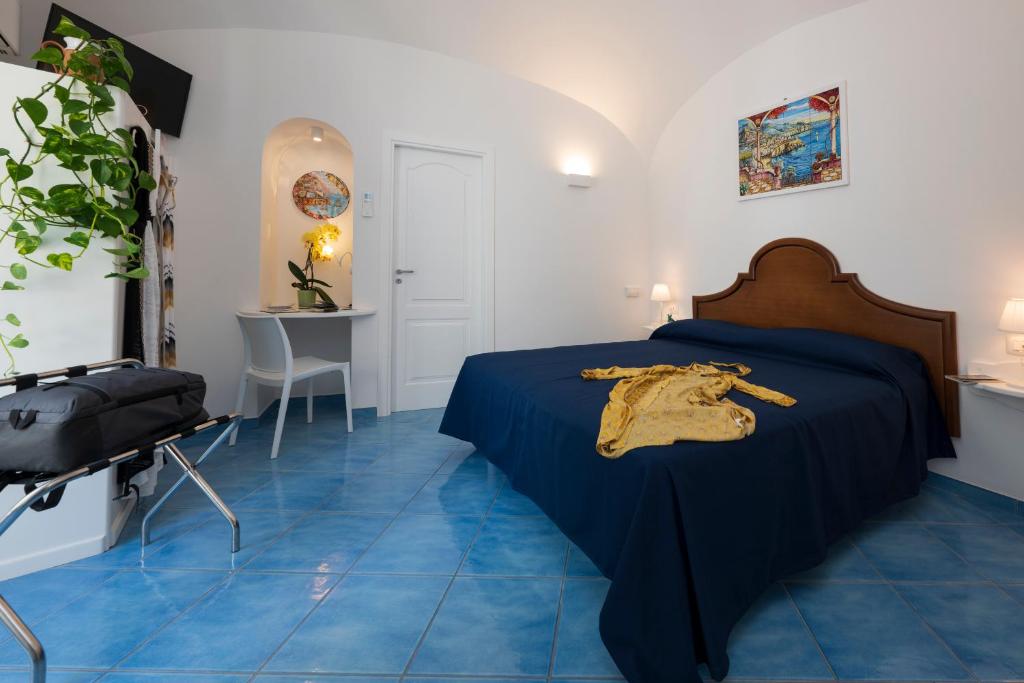 a bedroom with blue tiled floors and a bed at Secret Amalfi - Your stay in downtown Amalfi in Amalfi