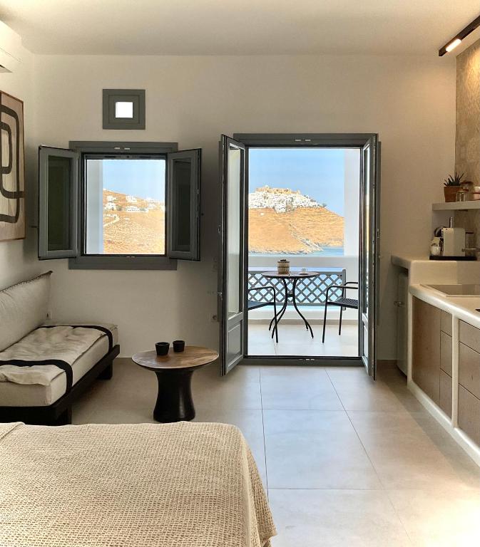 a room with a bed and a table with a view at Salvia di Astypalea in Livadi Astypalaias