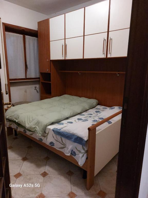 a small bedroom with a bed and white cabinets at # Punto FM 8# in Venice
