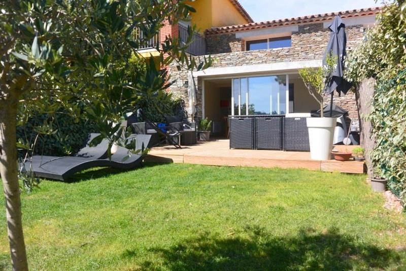 une arrière-cour avec une maison avec une pelouse et un parasol dans l'établissement Mazet les Issambres, Sainte Maxime, aux Issambres