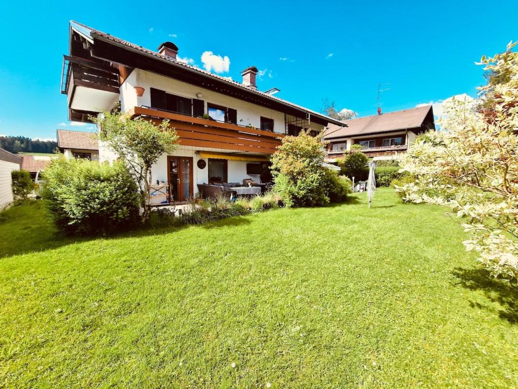 a large house with a yard in front of it at Christines Ferienwohnung in Weiler-Simmerberg