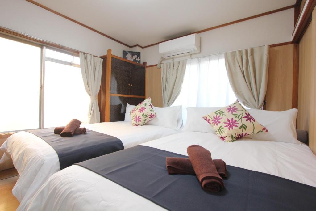 Postel nebo postele na pokoji v ubytování Hotel LUANA in Shin-Nakano