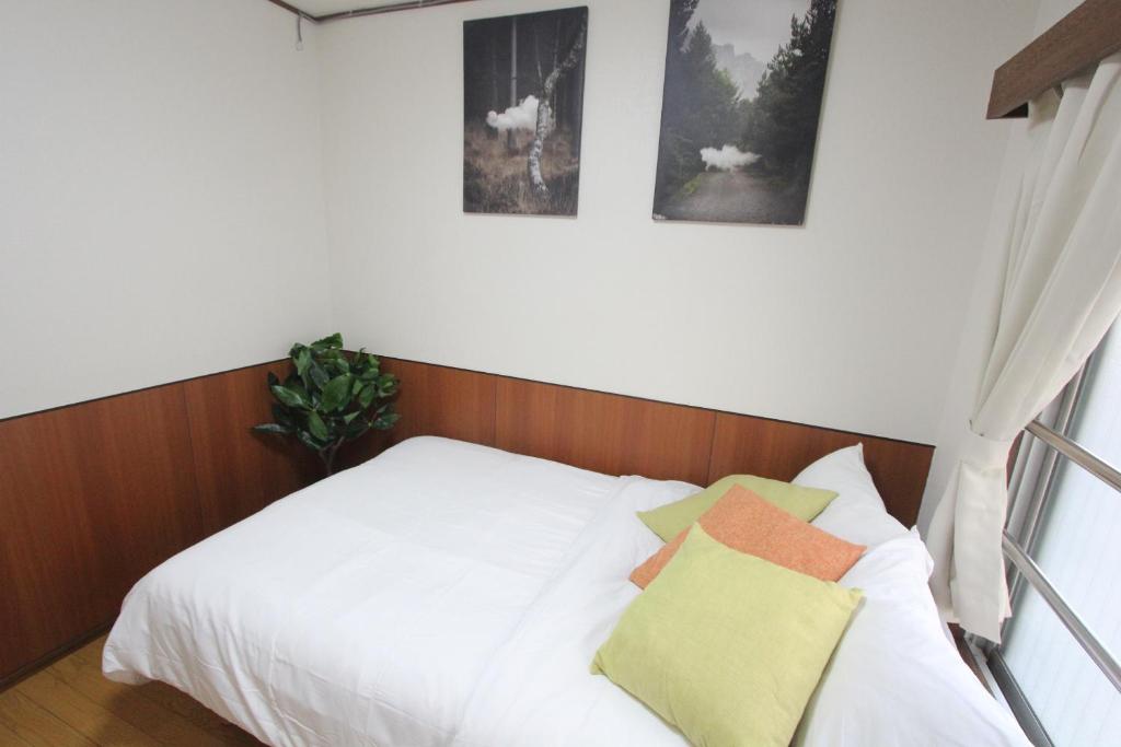 Postel nebo postele na pokoji v ubytování Hotel LUANA in Shin-Nakano