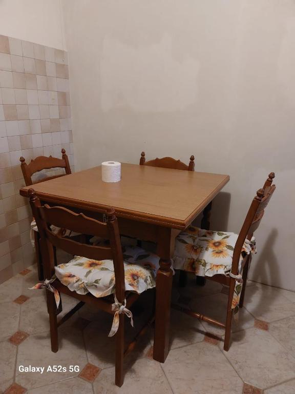 a wooden table with two chairs and a table with at # Punto FM 9 # in Marghera