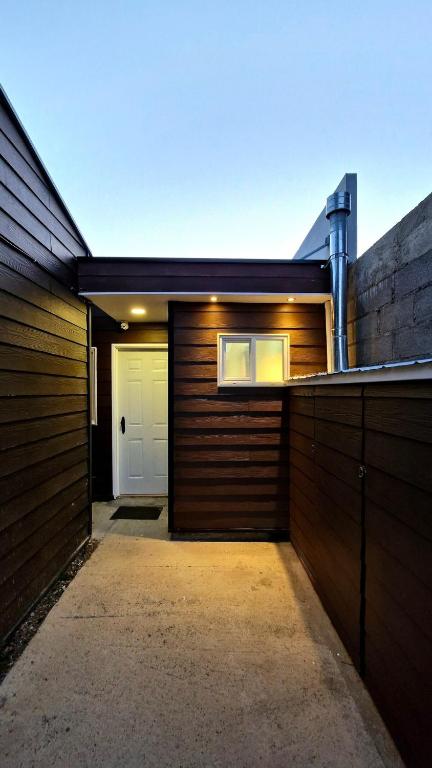 a garage with a white door and a building at Beautiful Independent House in Punta Arenas