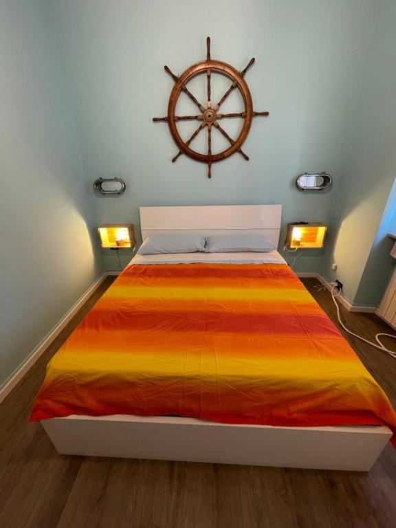 a bedroom with a bed with a nautical wheel on the wall at Matilde House a Genova, Boccadasse, appartamento completo ed esclusivo in Genova