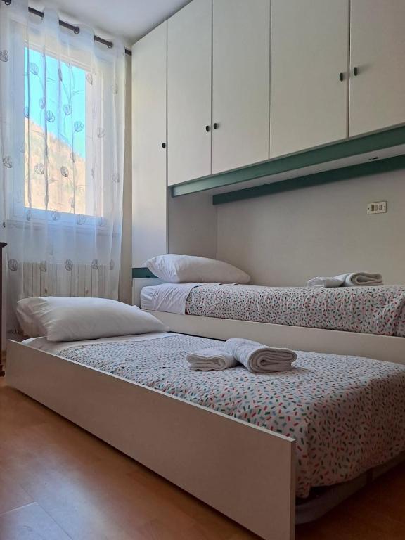 Postel nebo postele na pokoji v ubytování Appartamento A Càsa dei Nòni