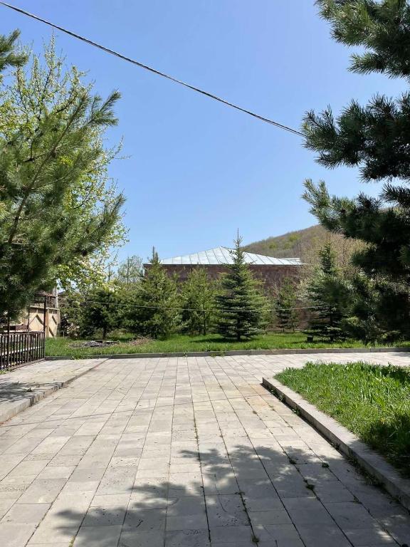 an empty parking lot with trees and a building at Dream House in Tsaghkadzor