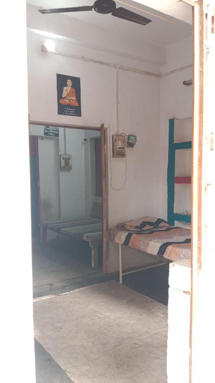 a room with two bunk beds and a mirror at kesharwani homes in Prayagraj