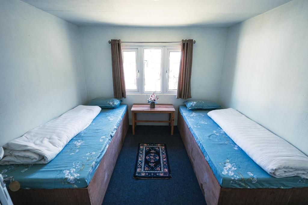 Postel nebo postele na pokoji v ubytování Amadablam Base Camp Lodge