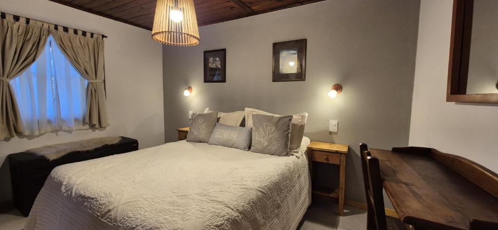 Postel nebo postele na pokoji v ubytování Hospedaje Mi Rincón El Chaltén