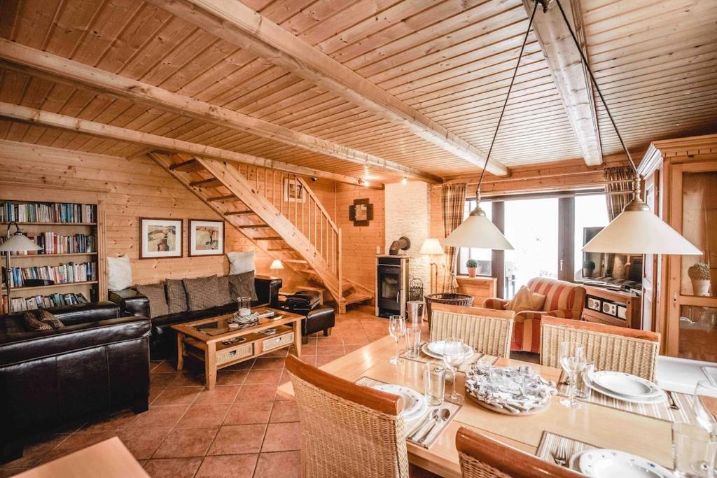 a large living room with a table and a couch at Schmuckstück in Hasselfelde