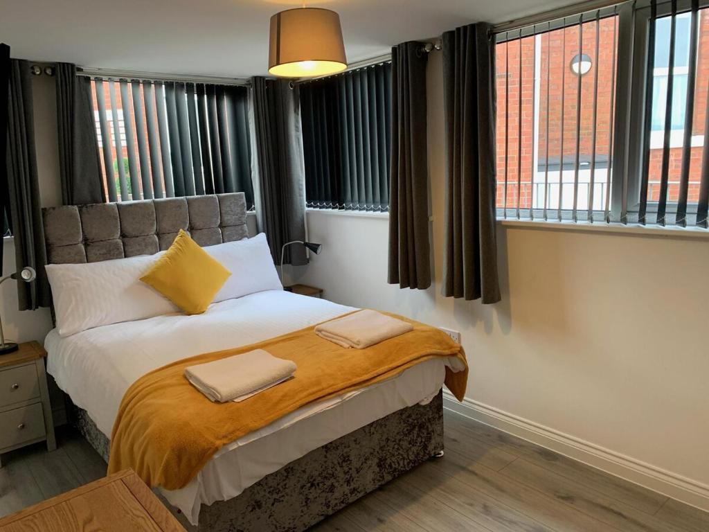a bedroom with a bed with two towels on it at Waterloo 3 bed bungalow by the station in Plymouth