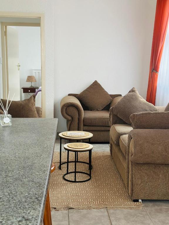 a living room with a couch and a table at La Same Homestead in Margate
