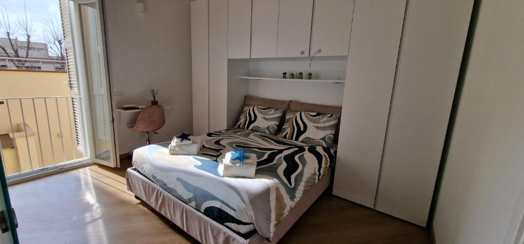 Postel nebo postele na pokoji v ubytování Oltremare Nettuno