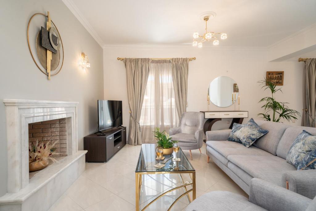 a living room with a couch and a fireplace at Irene Luxury Villa in Metaxáta