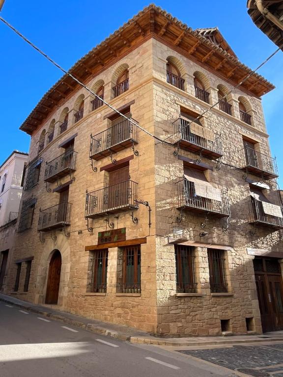 a brick building with balconies on the side of it at LA CASA DEL JAIME in Mora de Rubielos