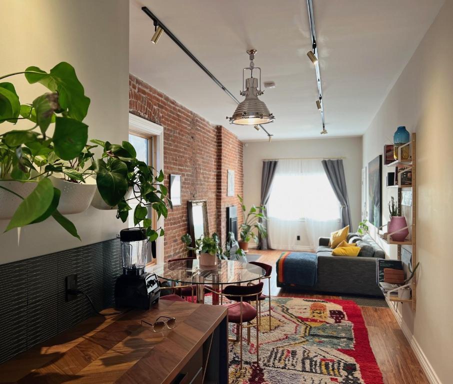 a living room with a couch and a brick wall at Awesome Remodeled House in Denver
