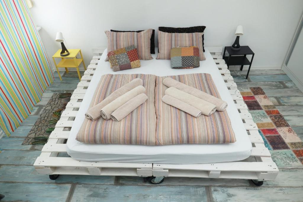 a white bed with pillows on it in a room at Nensica in Vukovar